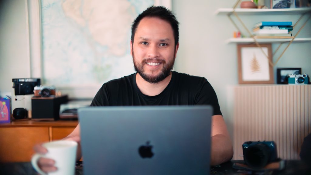 Ian Norman of lonelyspeck.com sitting at his computer.