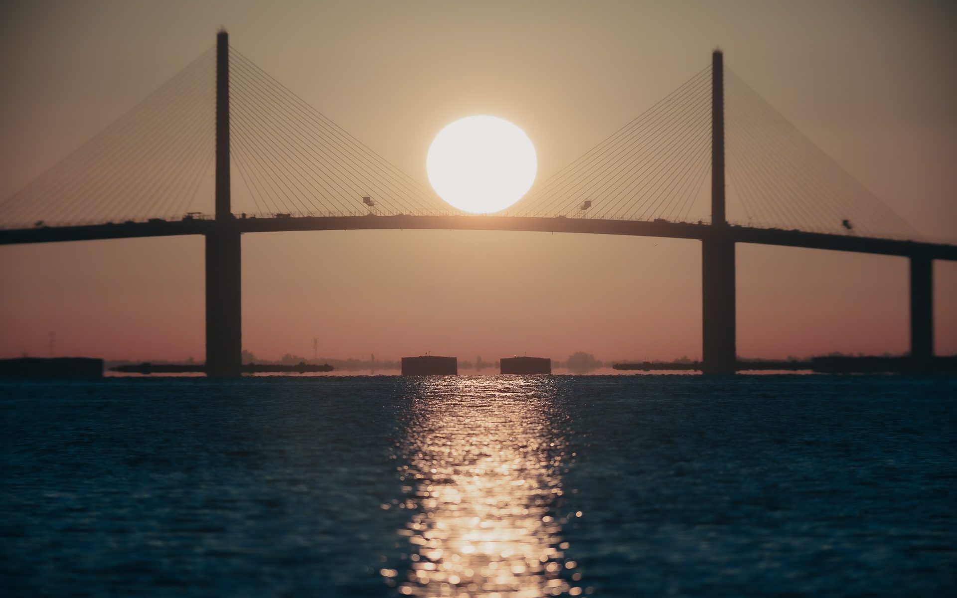 The Sun rising over Sunshine Skyway Bridge.